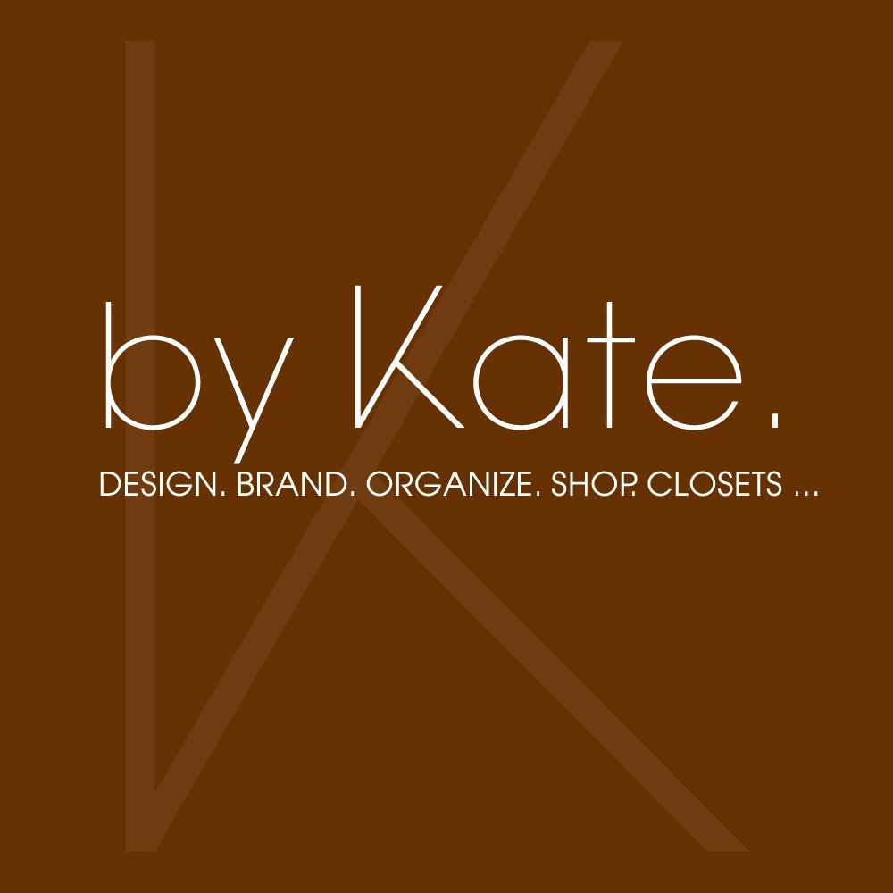 A brown background with white lettering that says by kate.